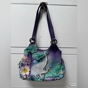 Anuschka hand painted amethyst color leather purse.